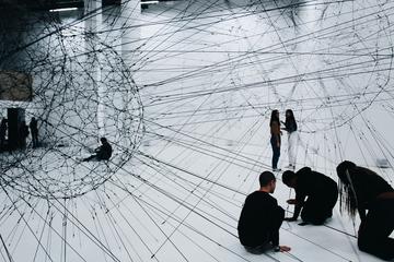 figures of young people standing or sitting in a white space overlaid by a sketch of network connections