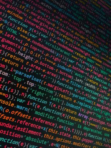 Tilted photo of coding text on a black screen