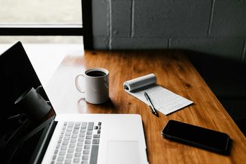 laptop on a table with a coffee
