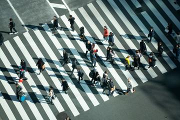 Different people crossing a road