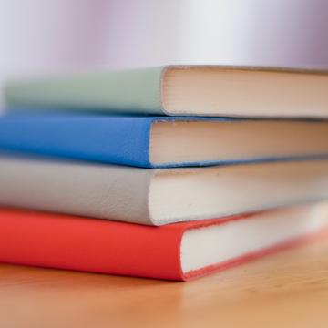 Photo of a stack of three diaries, each in different colour