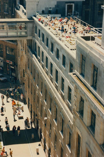 Photo of one of the terrace of one of LSE buildings, where a lot of people are njoying the sunny weather. 