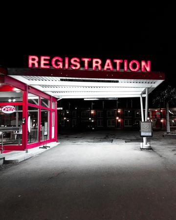 Neon sign at a petrol station saying "registration"
