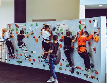 6 kids on a climbing wall