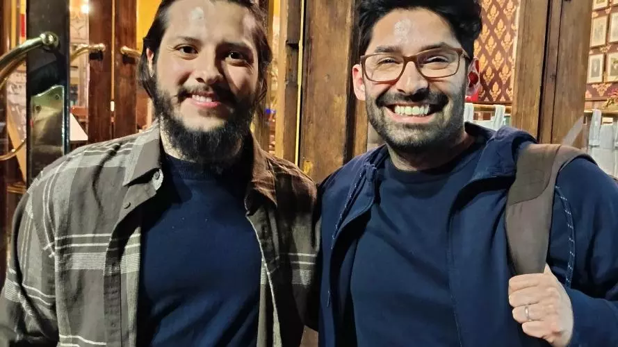 Two men smiling to the camera