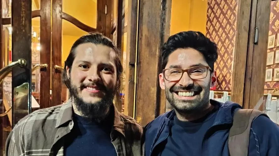 Two men smiling to the camera
