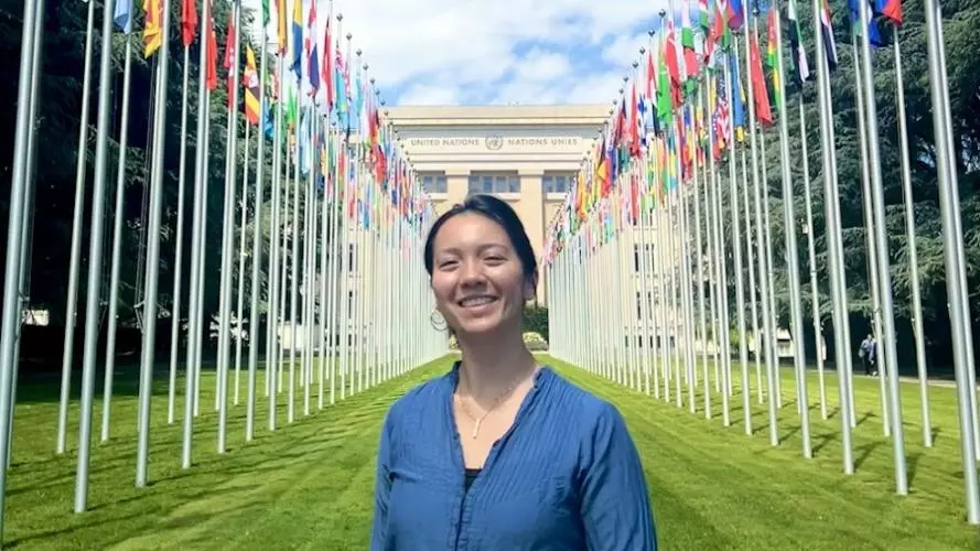 The author in front of flags at the ILO headquarters