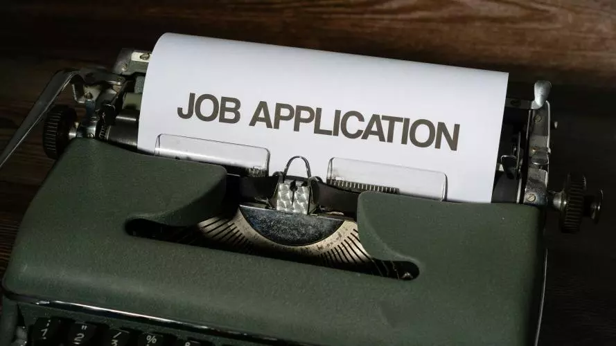 A typewriter with a Job application within
