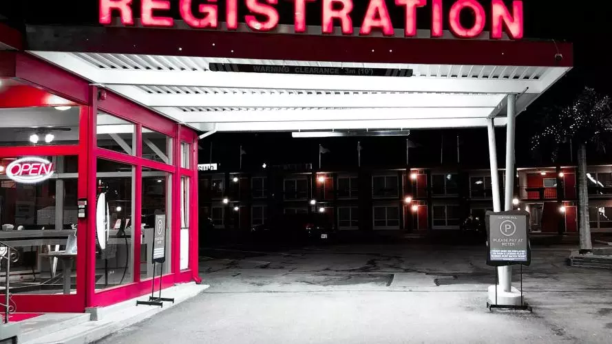 Neon sign at a petrol station saying "registration"