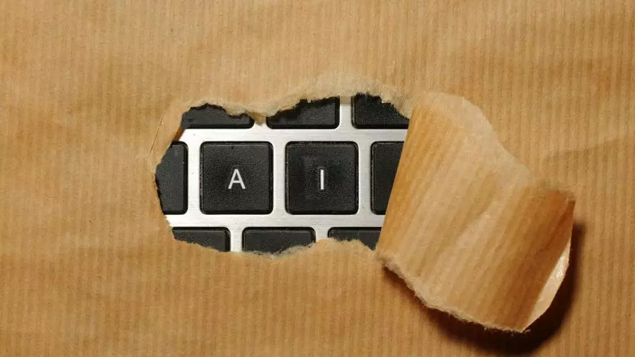 A piece of cardboard with a keyboard showing AI appearing