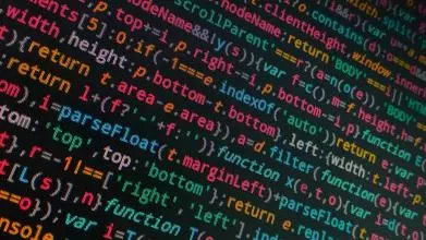 Tilted photo of coding text on a black screen
