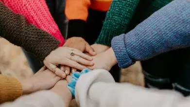 seven hands together