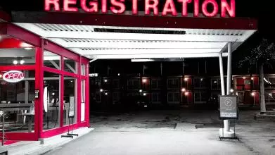 Neon sign at a petrol station saying "registration"