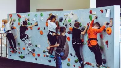 6 kids on a climbing wall