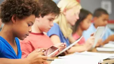 Pupils In Class Using Digital Tablet