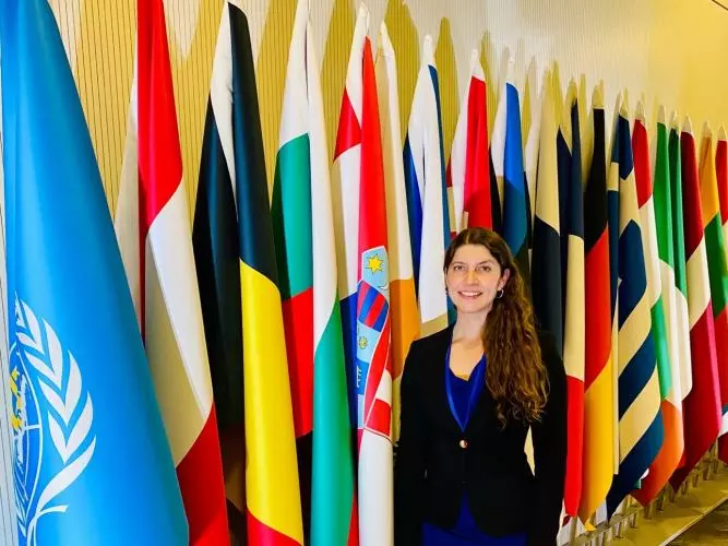 Denise Kohlhepp in front of UN flags.