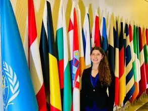 Denise Kohlhepp in front of UN flags.