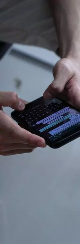 Person holding a black iPhone 4