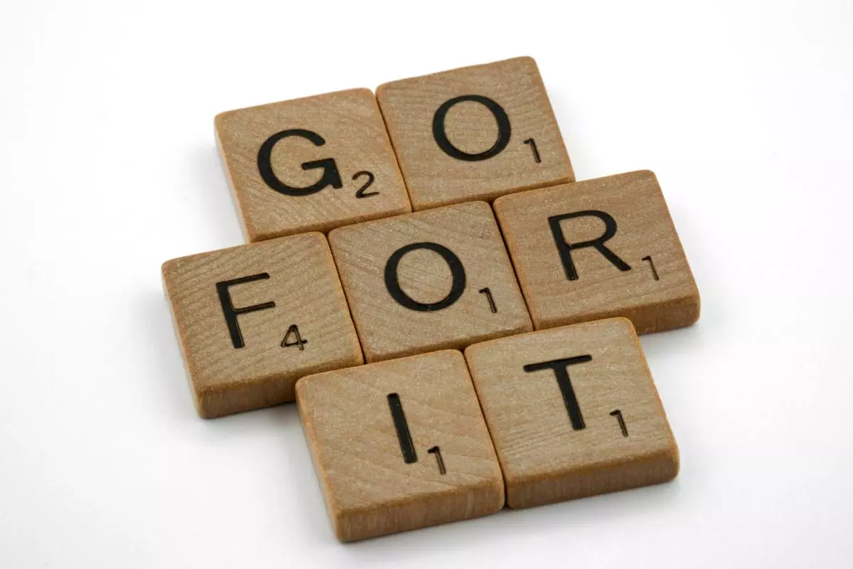 Scrabble tiles making the phrase 'Go for it'