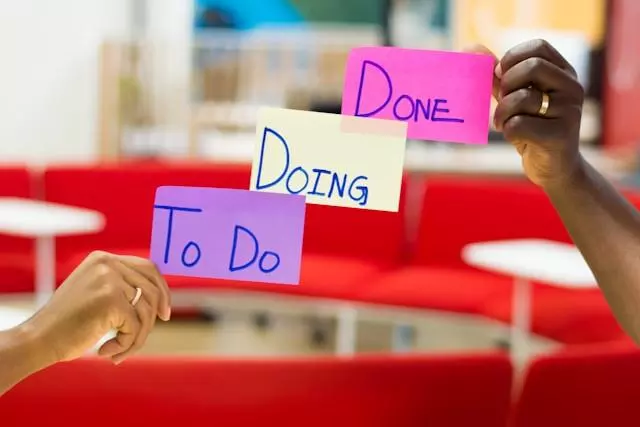 three post-it notes reading to do, doing, done, stuck on a transparent board